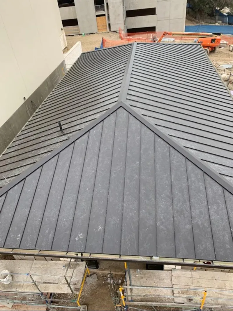 Commercial metal roof construction with crane equipment in Neshannock